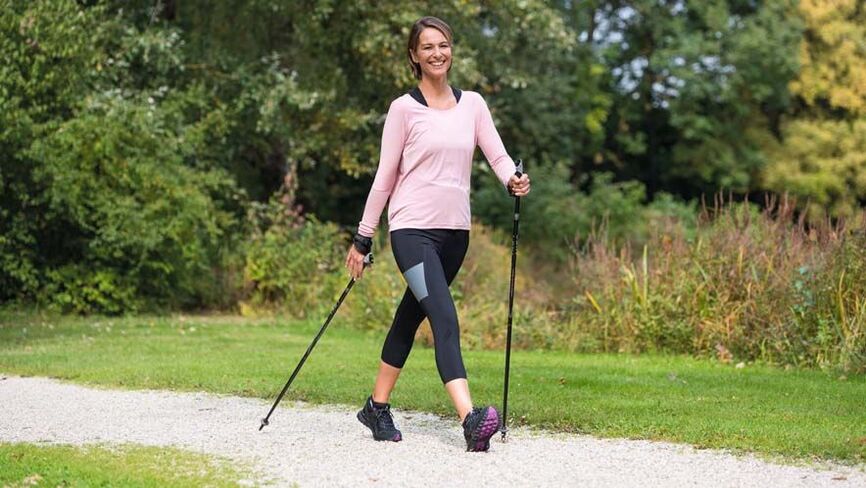 the woman is busy walking to prevent back pain
