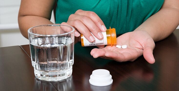 taking pills to relieve lower back pain